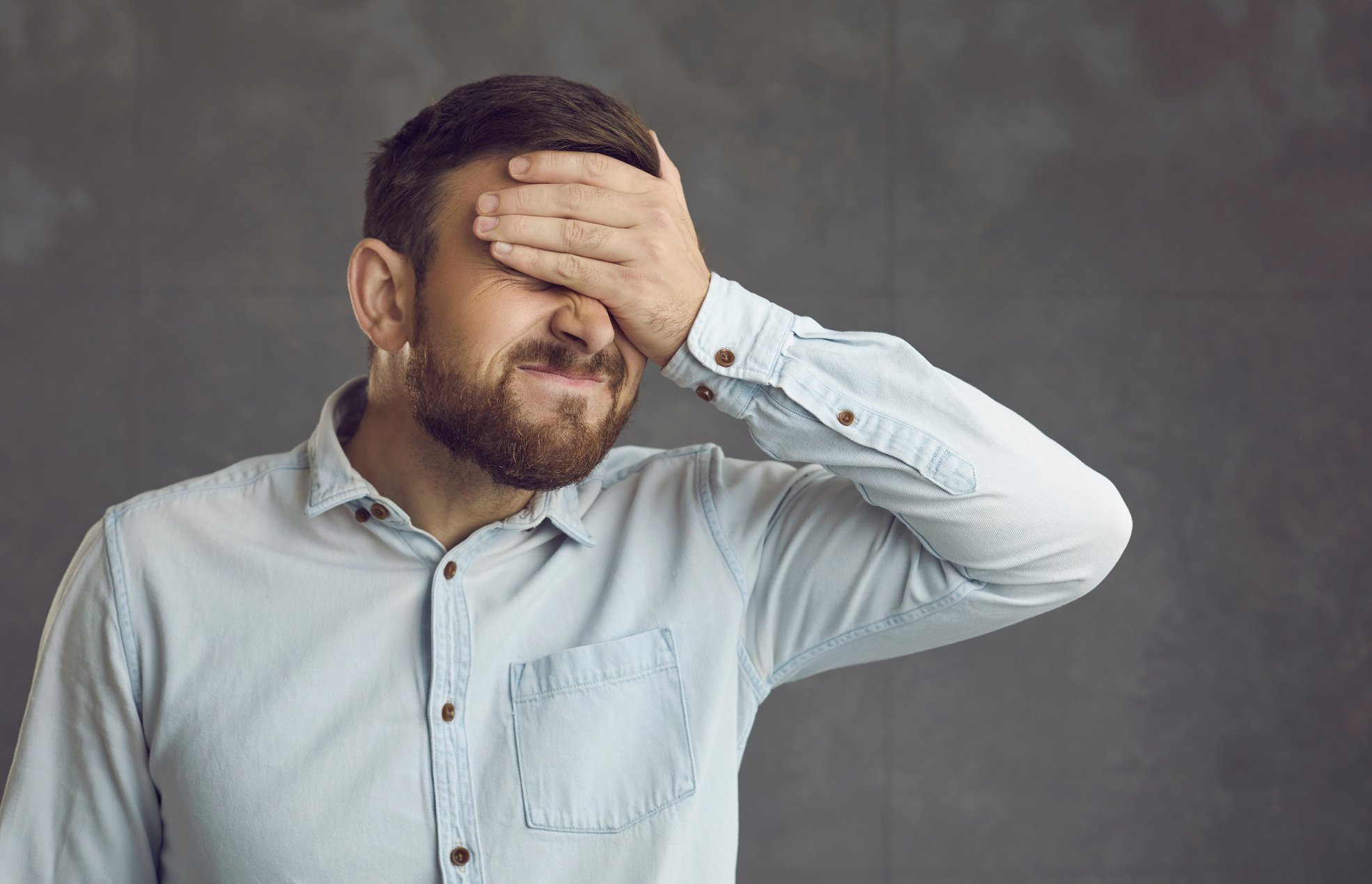 Man Facepalming Feeling Awfully Ashamed and Embarrassed of a Stupid Mistake He's Made