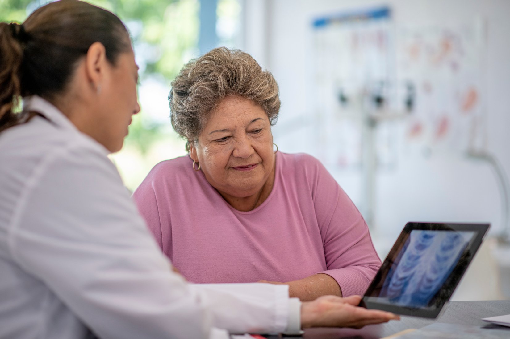 Hispanic senior adult woman at doctor's office