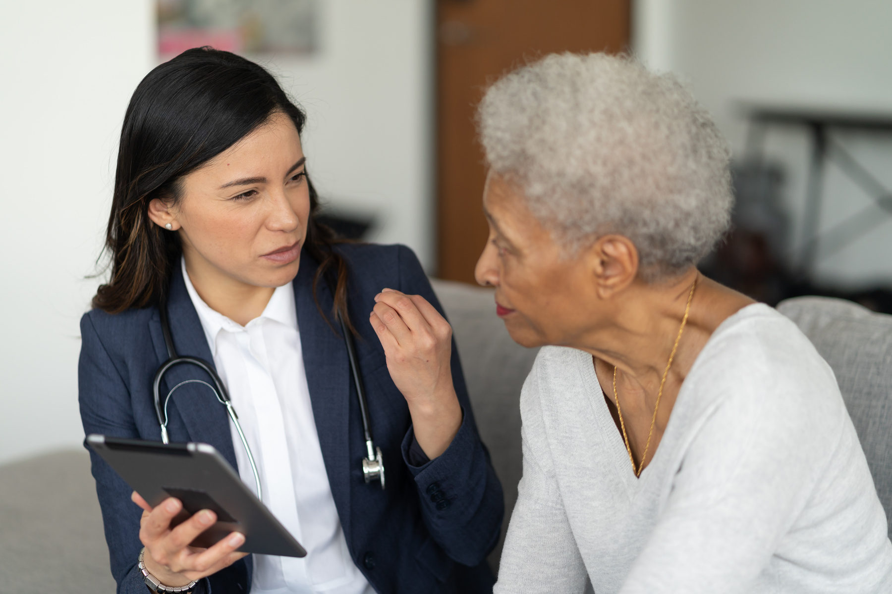 Young doctor with elderly patient