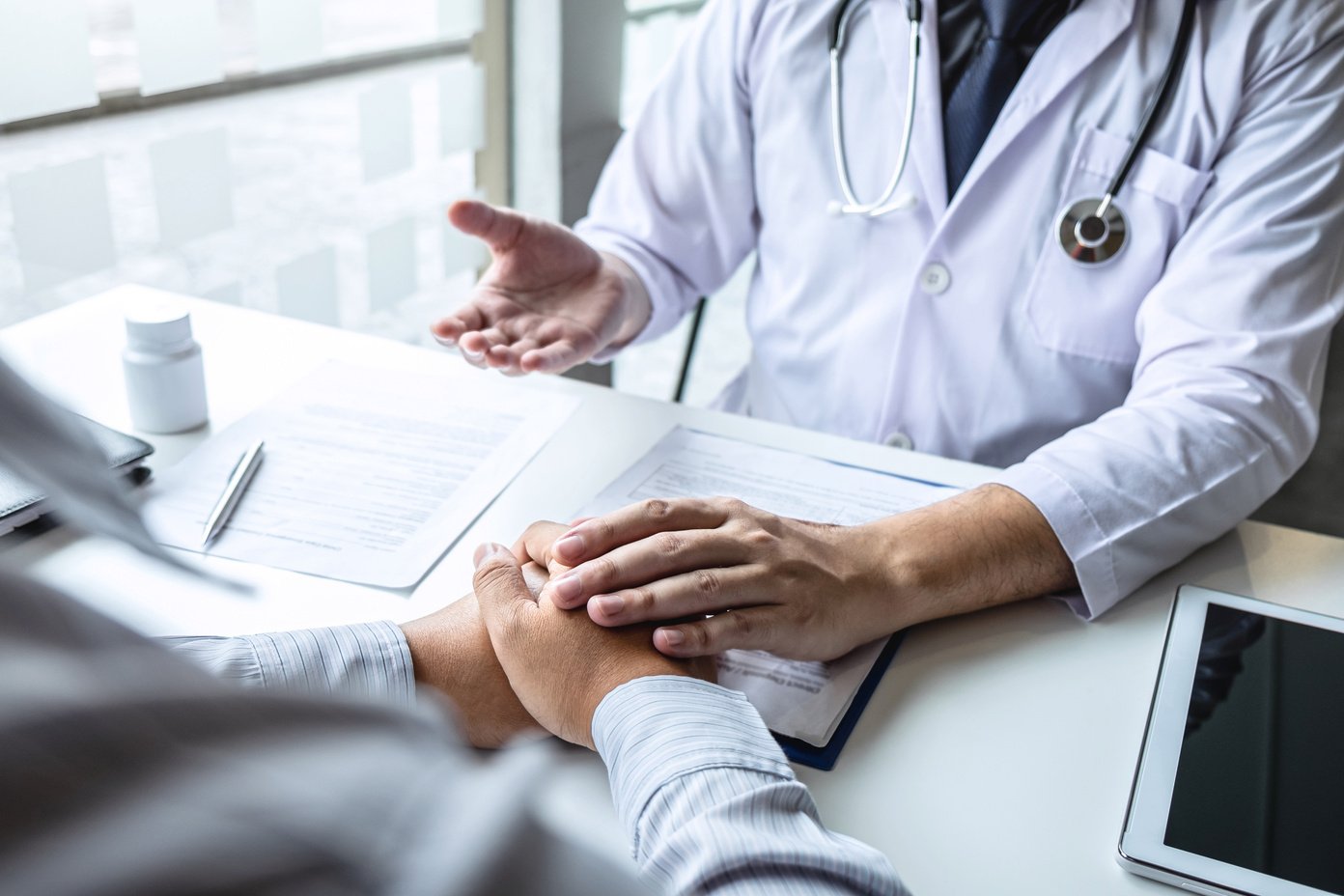 Doctor Holding Patient's Hand After a Diagnosis 