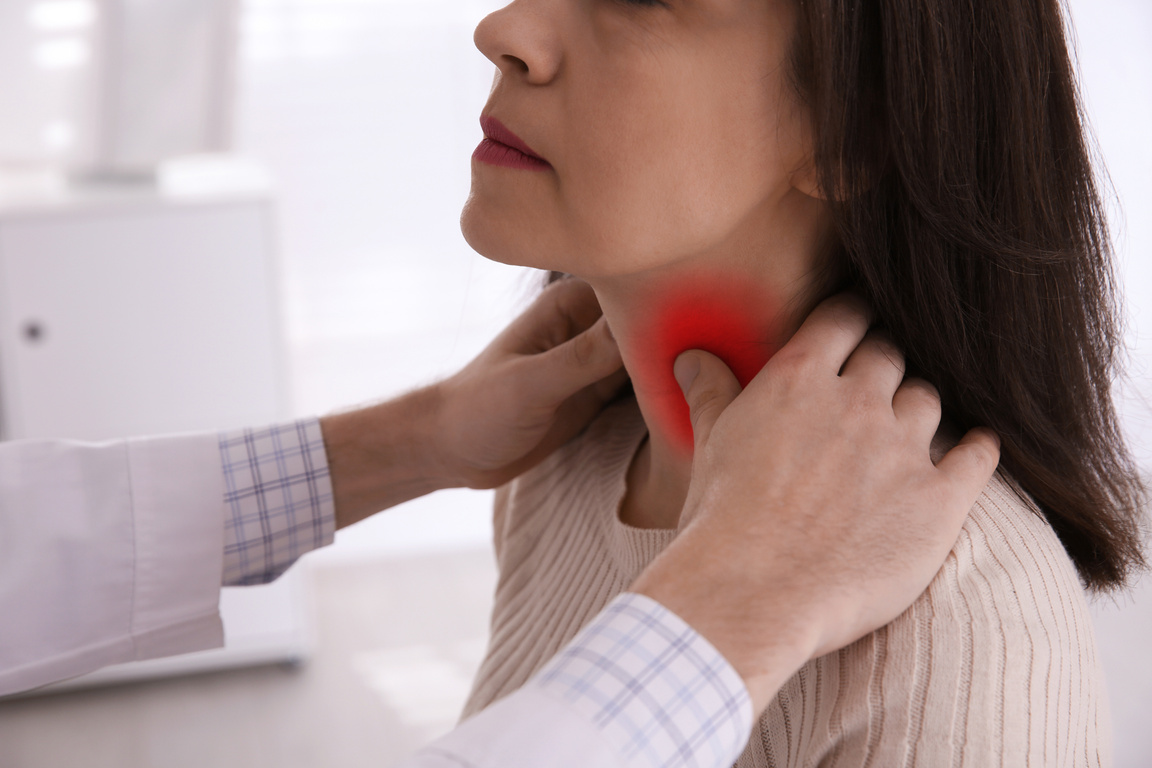 Endocrine System. Doctor Examining Patient's Thyroid Gland in Hospital, Closeup